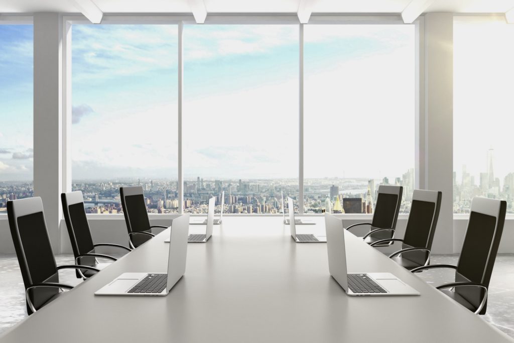 Modern,conference,room,with,furniture,,laptops,,big,windows,and,city